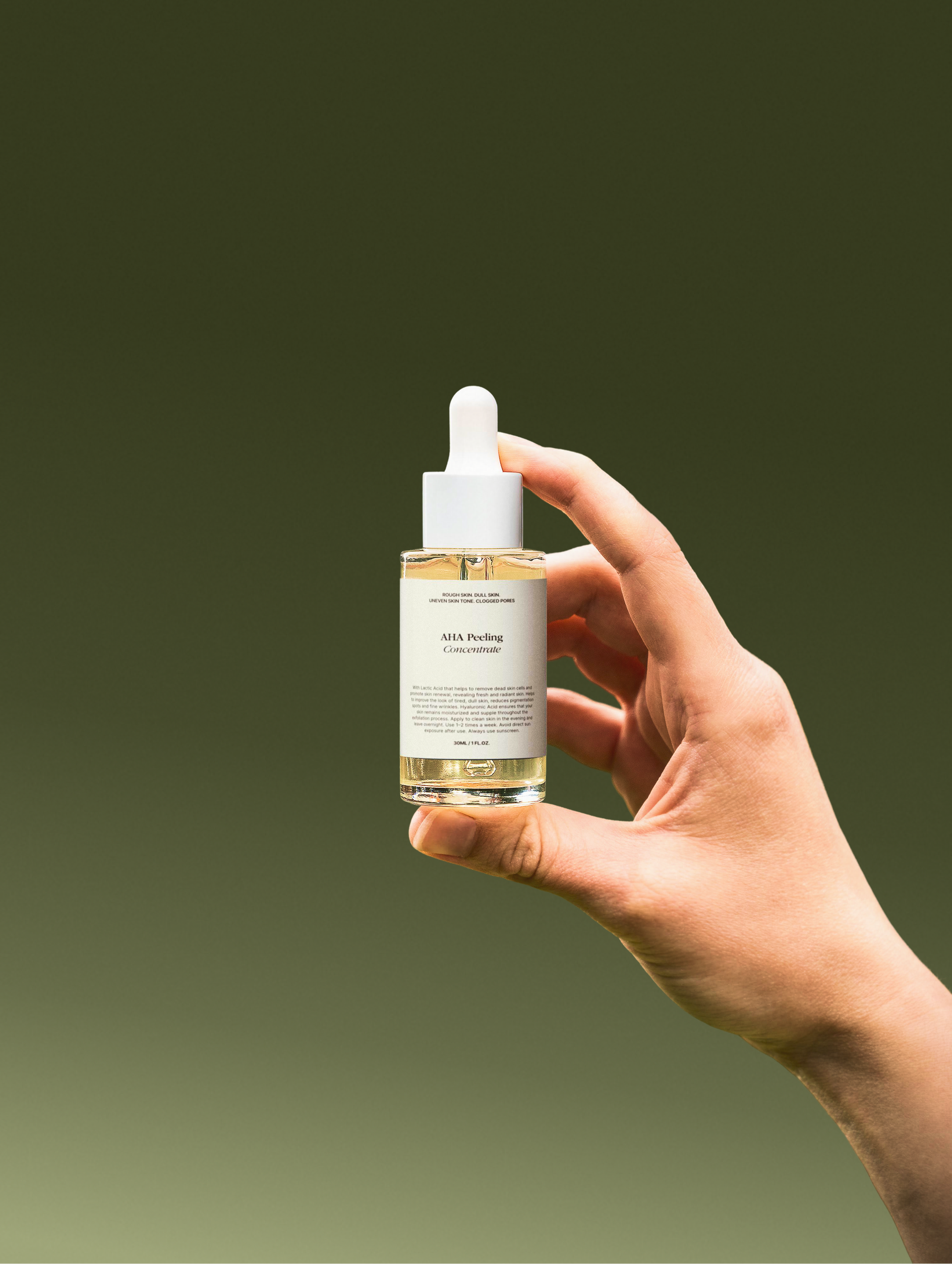 Hand holding a skincare dropper bottle with a gradient green background