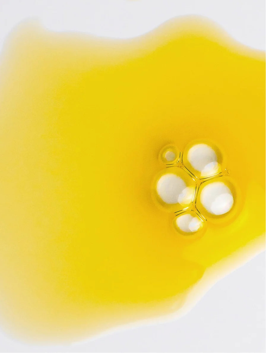 Yellow liquid with bubbles on a white background
