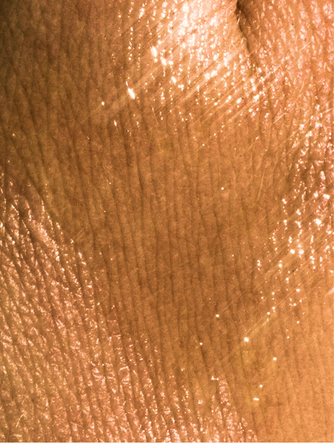 Close-up of bronze-colored skin texture